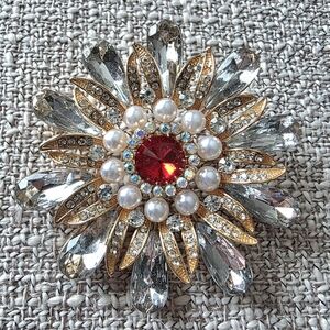Vintage gold tone flower brooch featuring Red & Clear Crystals & Pearls